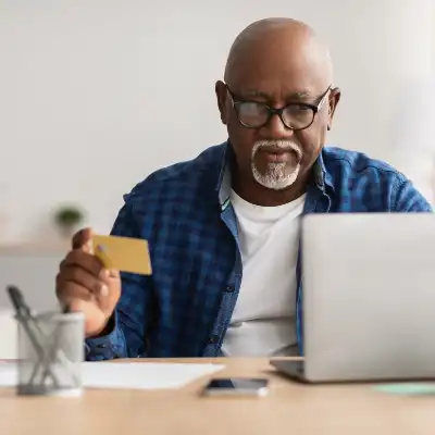older man paying bills